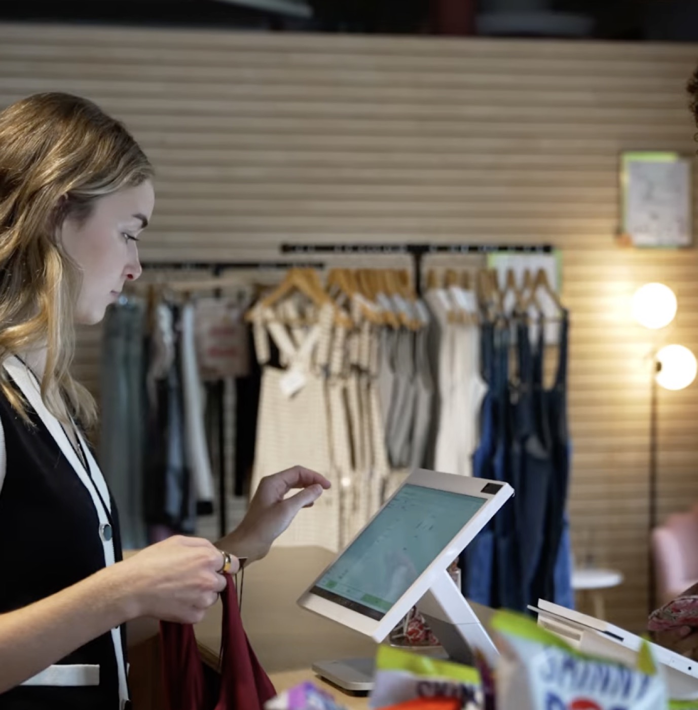 A student checking out a customer at House Of